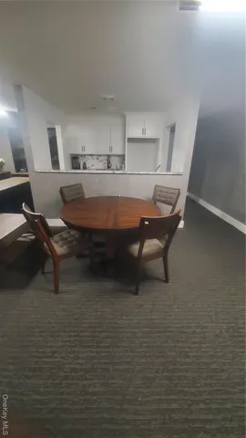 a room with table chairs and wooden floor