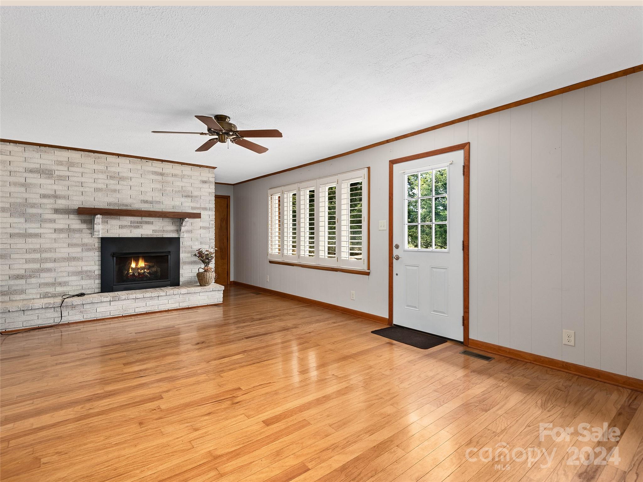 2356 Panther Creek Road Clyde, NC 28721 - Photo 9 of 22 a view of an empty room with a fireplace and a window
