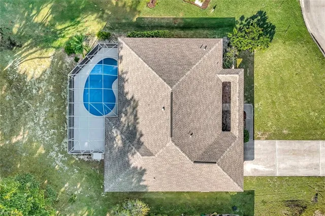 an aerial view of residential houses with outdoor space and ocean view