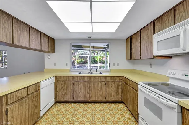 a kitchen with sink cabinets and window