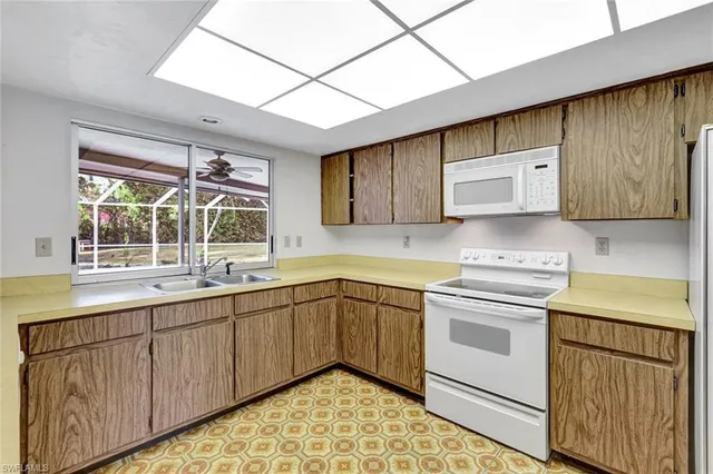 a utility room with cabinets washer and dryer