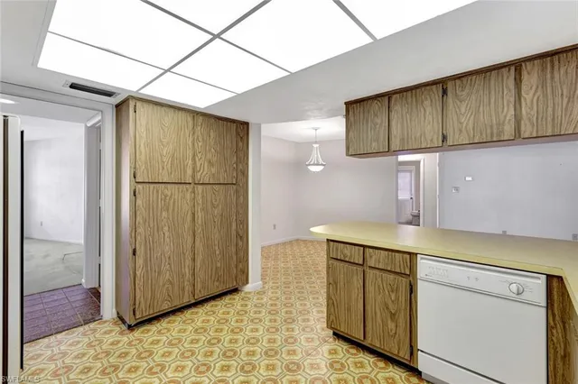 a kitchen with a refrigerator sink stove and cabinets