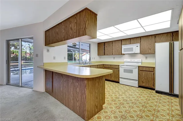 a view of empty room with wooden floor and windows