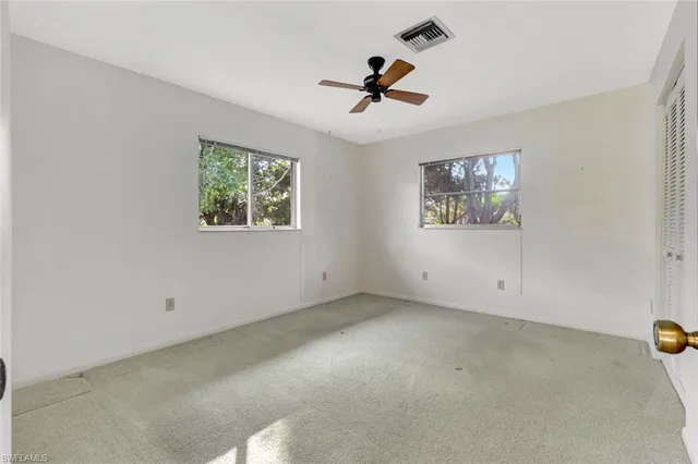 a bathroom with a granite countertop sink a toilet and a mirror