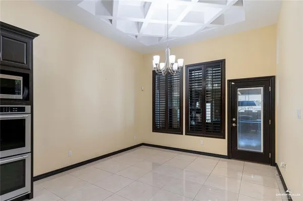 a large kitchen with a table and chairs