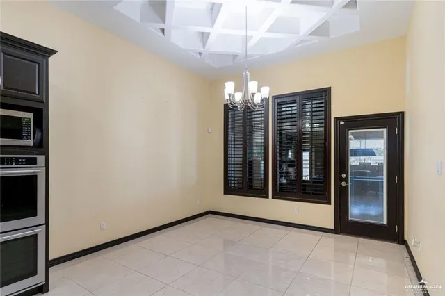 a large kitchen with a table and chairs