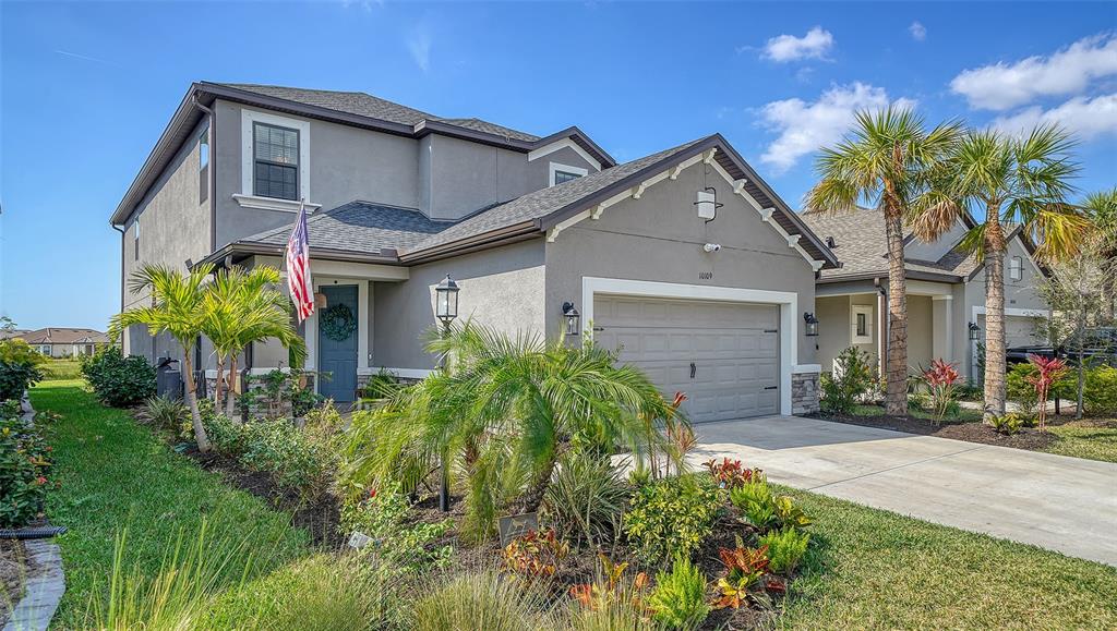 10109 Milky Way Circle Sarasota, FL 34241 - Photo 1 of 1 a front view of a house with a yard and potted plants