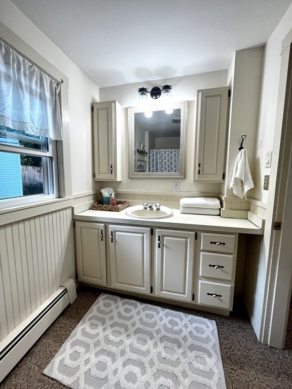 13 Wilson Street Clinton, MA 01510 - Photo 19 of 23 a view of cabinets with wooden floor and electronic appliances