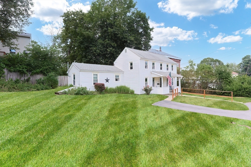 13 Wilson Street Clinton, MA 01510 - Photo 2 of 23 a view of a house with a big yard and large trees