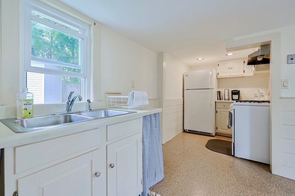 13 Wilson Street Clinton, MA 01510 - Photo 9 of 23 a kitchen with white cabinets and refrigerator