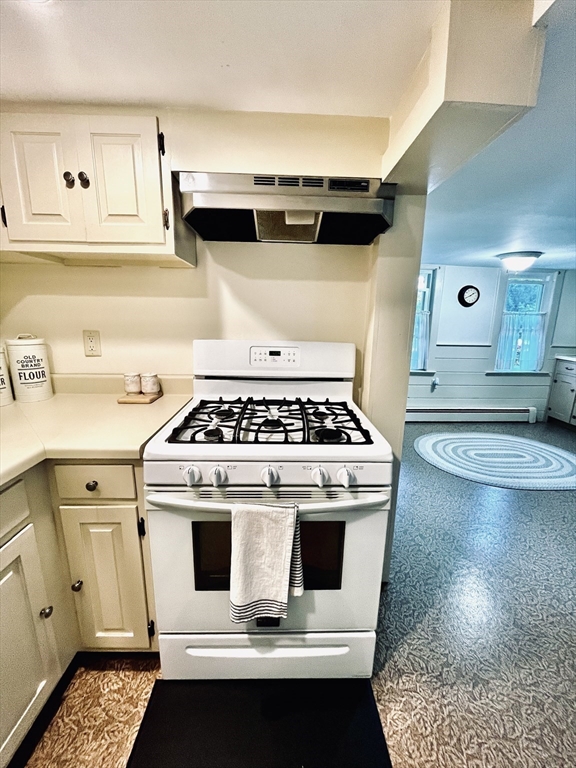 13 Wilson Street Clinton, MA 01510 - Photo 10 of 23 a white stove top oven sitting inside of a kitchen