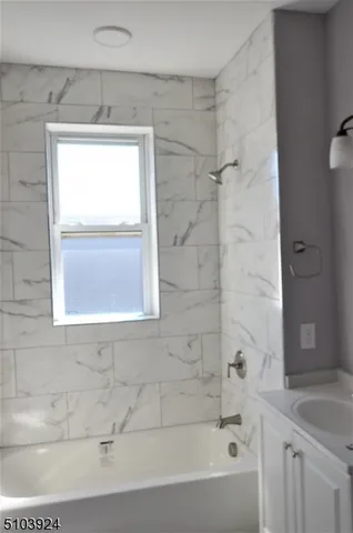 a bathroom with a bathtub and a shower