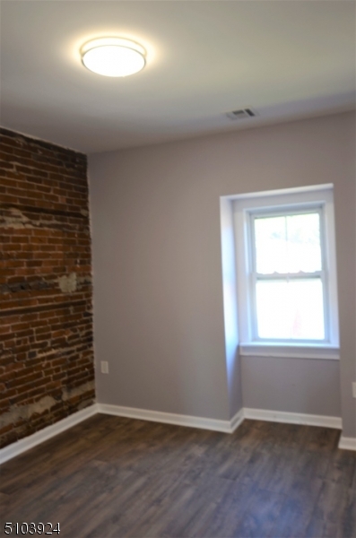 154 South Main Street Phillipsburg, NJ 08865 - Photo 9 of 12 an empty room with wooden floor and windows