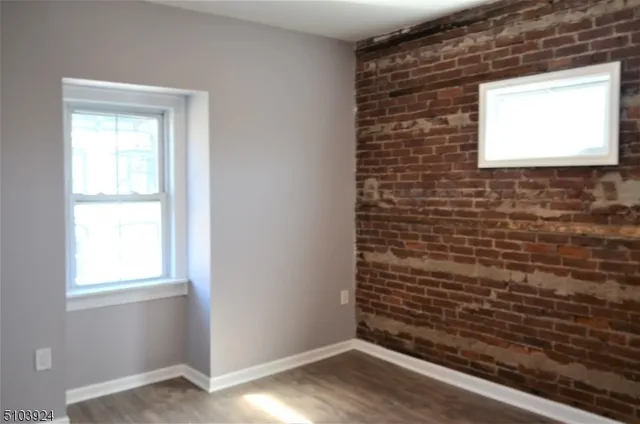 a view of an empty room and wooden floor
