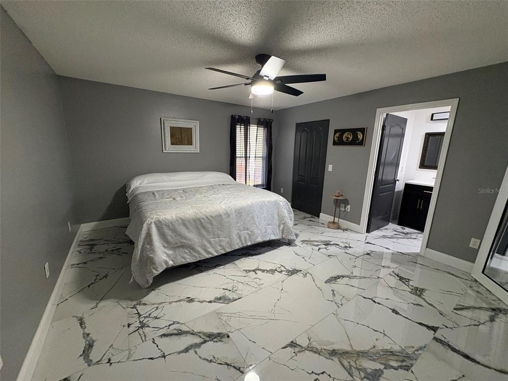 3123 East Marcia Street Inverness, FL 34453 - Photo 11 of 32 a bedroom with a large bed and a window