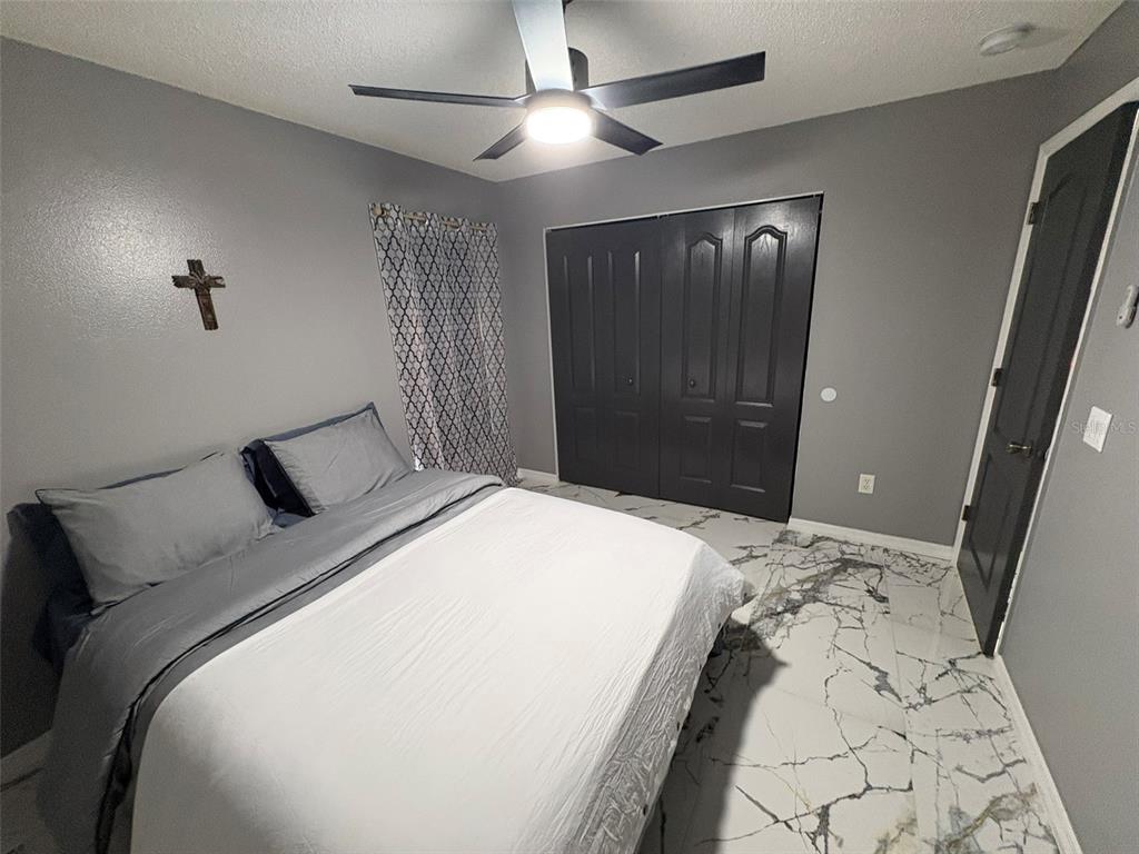 3123 East Marcia Street Inverness, FL 34453 - Photo 17 of 32 a bedroom with a bed and a walk in closet