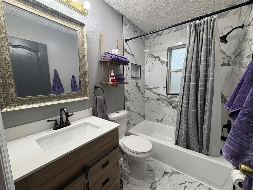 3123 East Marcia Street Inverness, FL 34453 - Photo 20 of 32 a bathroom with a sink a toilet and shower