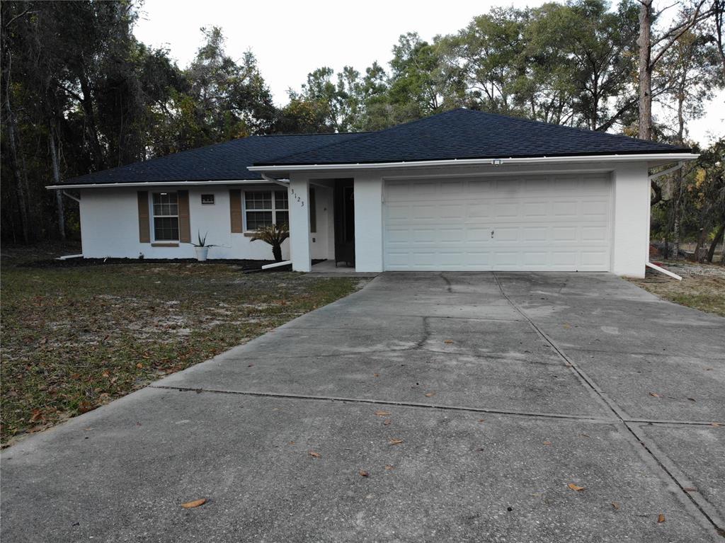 3123 East Marcia Street Inverness, FL 34453 - Photo 2 of 32 a front view of a house with garden