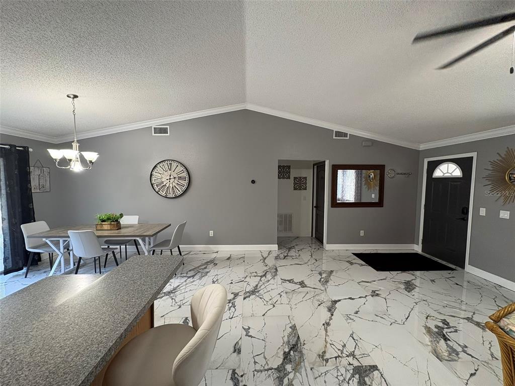 3123 East Marcia Street Inverness, FL 34453 - Photo 3 of 32 a bedroom with a bed chandelier and a window