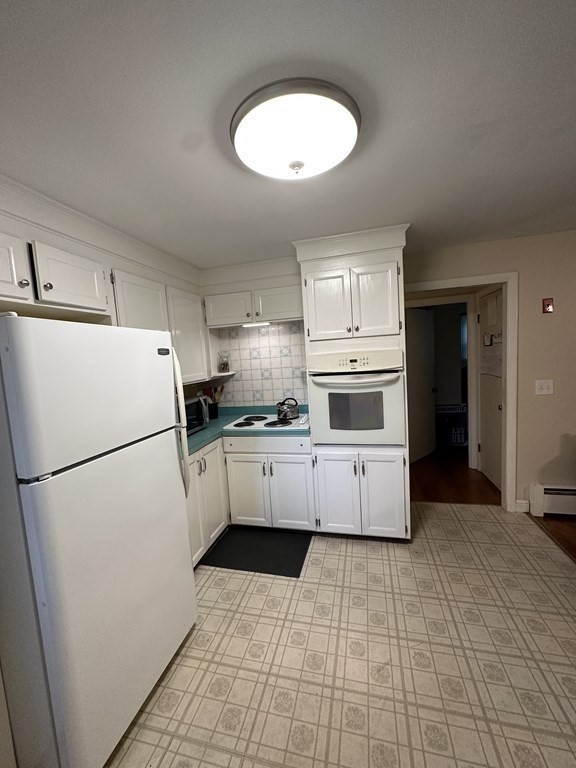 26 Bigelow Road Lancaster, MA 01523 - Photo 8 of 26 a white refrigerator freezer sitting inside of a kitchen