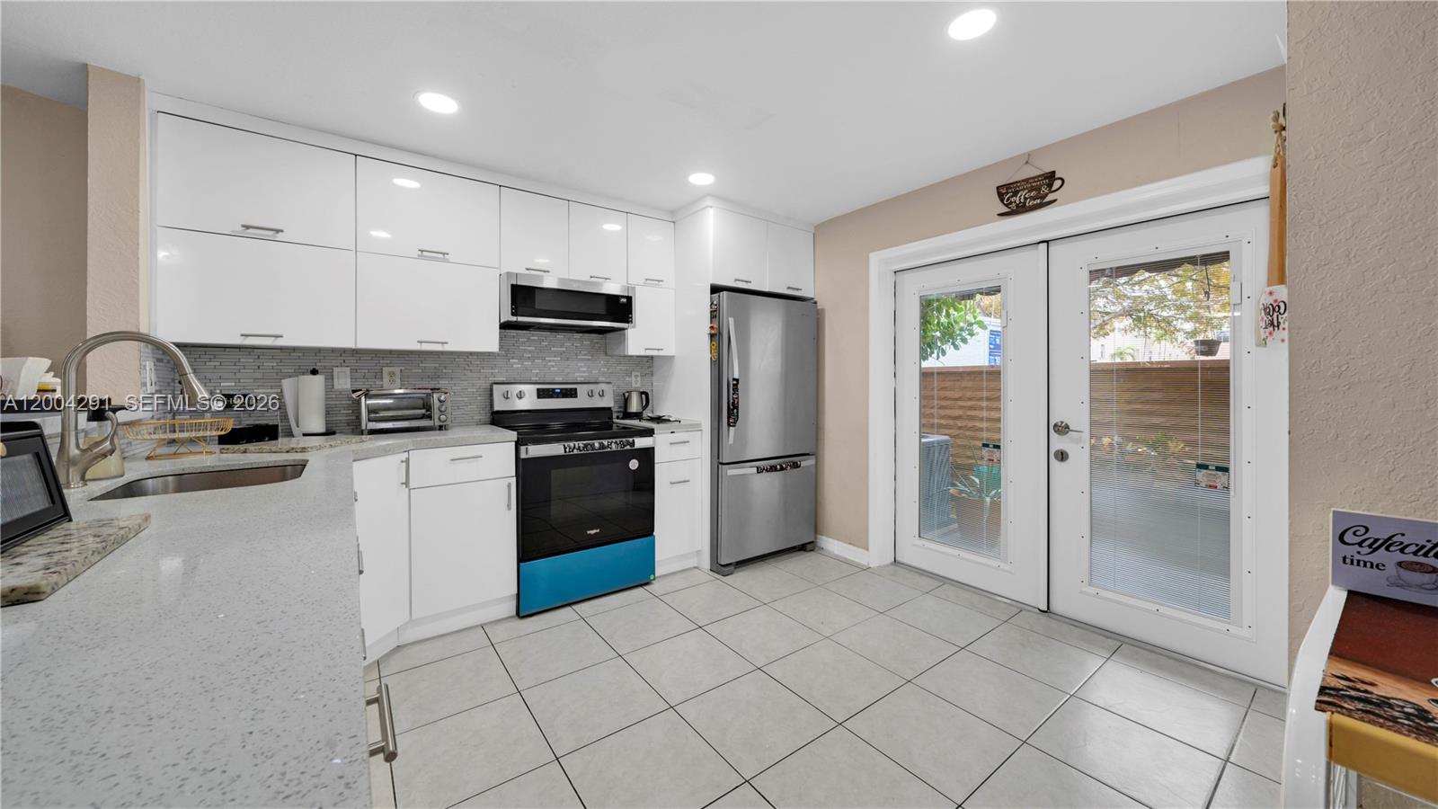 120 East 5th Street, Unit 2 Hialeah, FL 33010 - Photo 11 of 42 a kitchen with granite countertop a refrigerator and a stove top oven