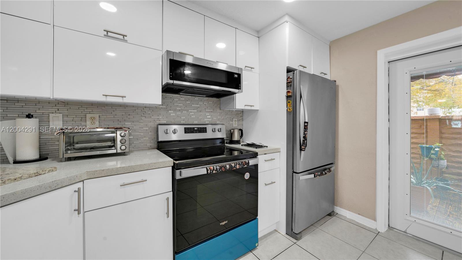 120 East 5th Street, Unit 2 Hialeah, FL 33010 - Photo 13 of 42 a kitchen with stainless steel appliances granite countertop a refrigerator a stove a sink and a granite counter tops