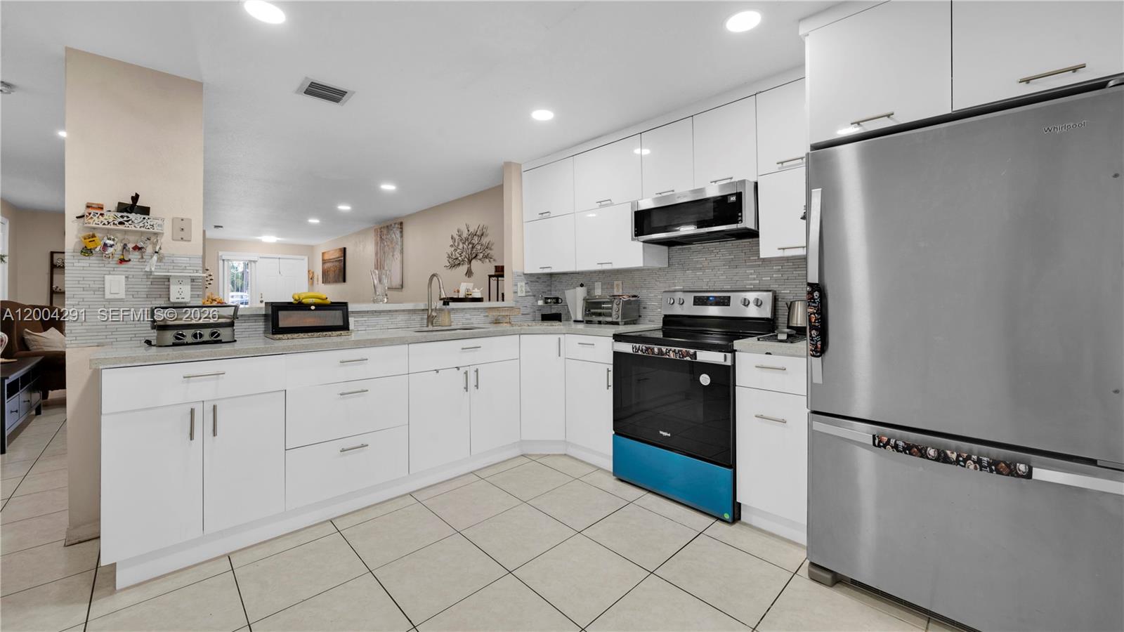 120 East 5th Street, Unit 2 Hialeah, FL 33010 - Photo 14 of 42 a kitchen with stainless steel appliances granite countertop a refrigerator sink and cabinets