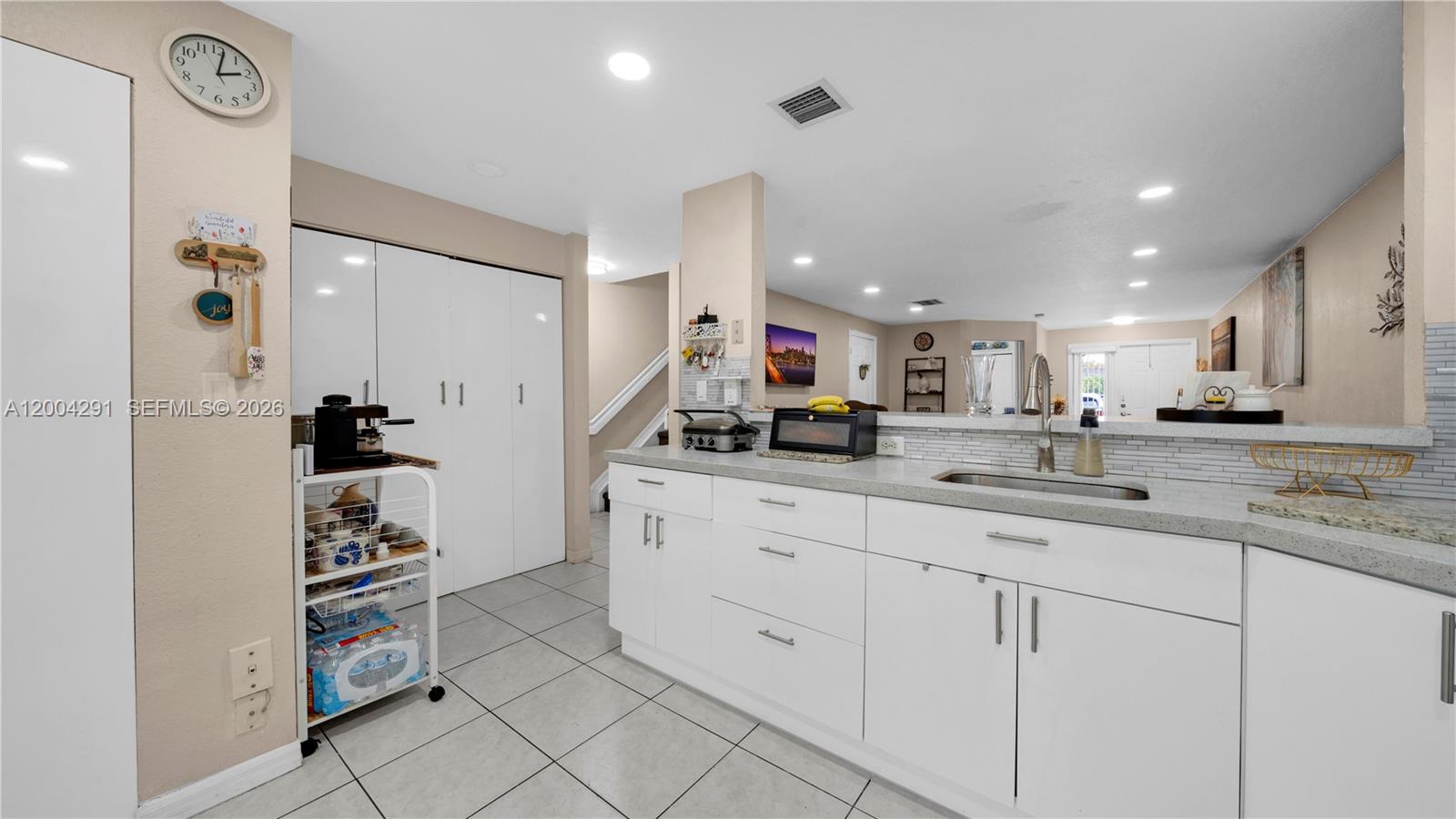 120 East 5th Street, Unit 2 Hialeah, FL 33010 - Photo 15 of 42 a kitchen with white cabinets and appliances