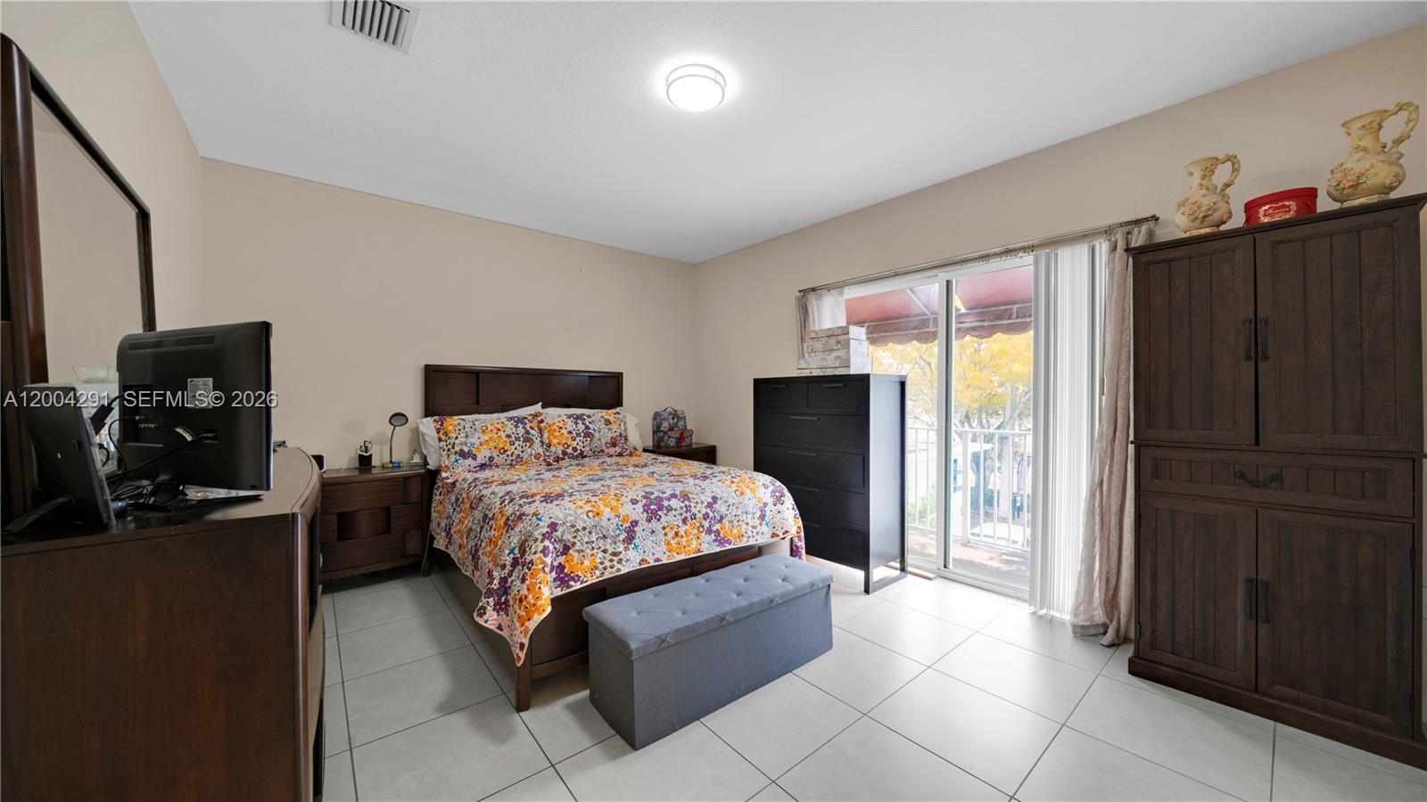 120 East 5th Street, Unit 2 Hialeah, FL 33010 - Photo 31 of 42 a bedroom with a bed and wooden floor