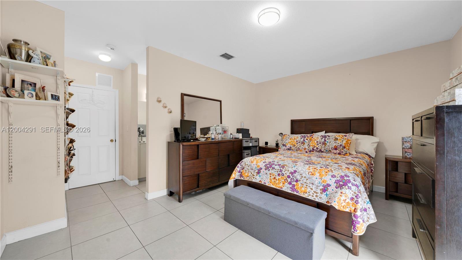 120 East 5th Street, Unit 2 Hialeah, FL 33010 - Photo 32 of 42 a bedroom with a bed and a refrigerator