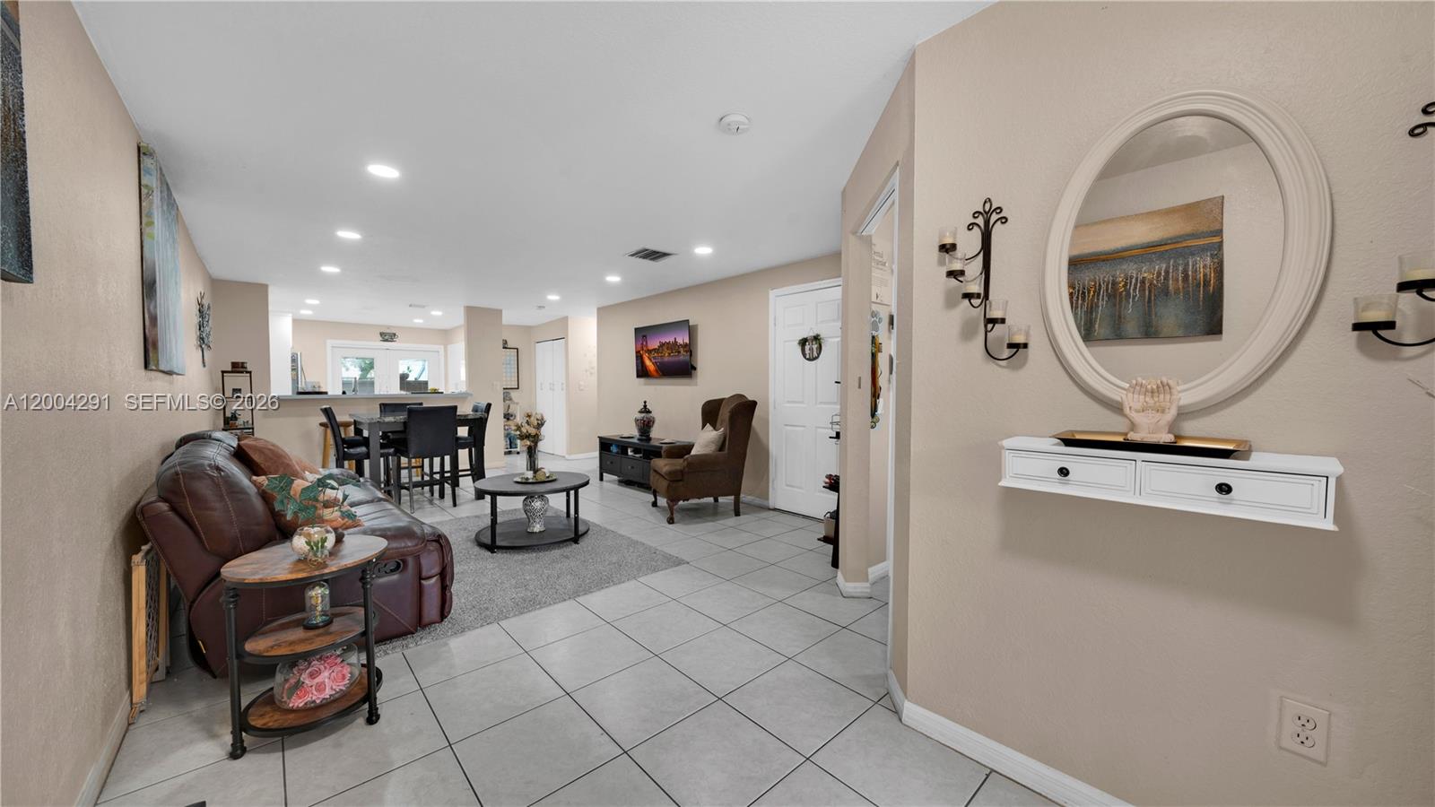 120 East 5th Street, Unit 2 Hialeah, FL 33010 - Photo 4 of 42 a living room with furniture and a mirror