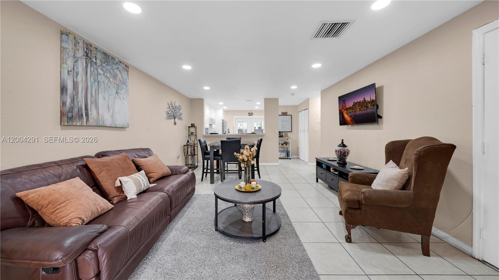 120 East 5th Street, Unit 2 Hialeah, FL 33010 - Photo 5 of 42 a living room with furniture a rug and a flat screen tv