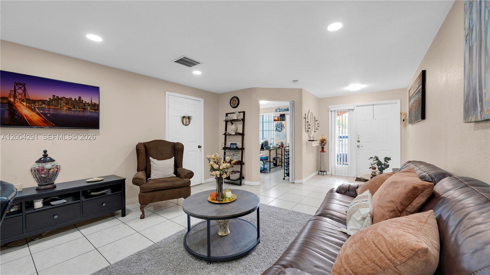 120 East 5th Street, Unit 2 Hialeah, FL 33010 - Photo 9 of 42 a living room with furniture and a flat screen tv