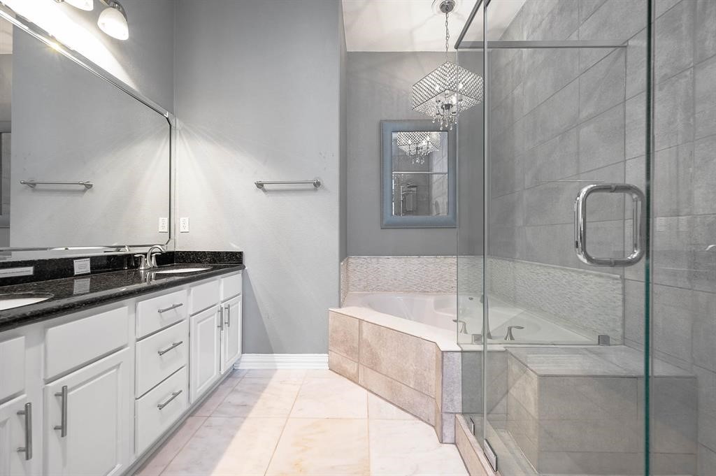 3507 Jackson Street Houston, TX 77004 - Photo 15 of 20 Primary bathroom with large vanity, granite countertop, a glass-enclosed shower and soaking tub, providing a luxurious experience.