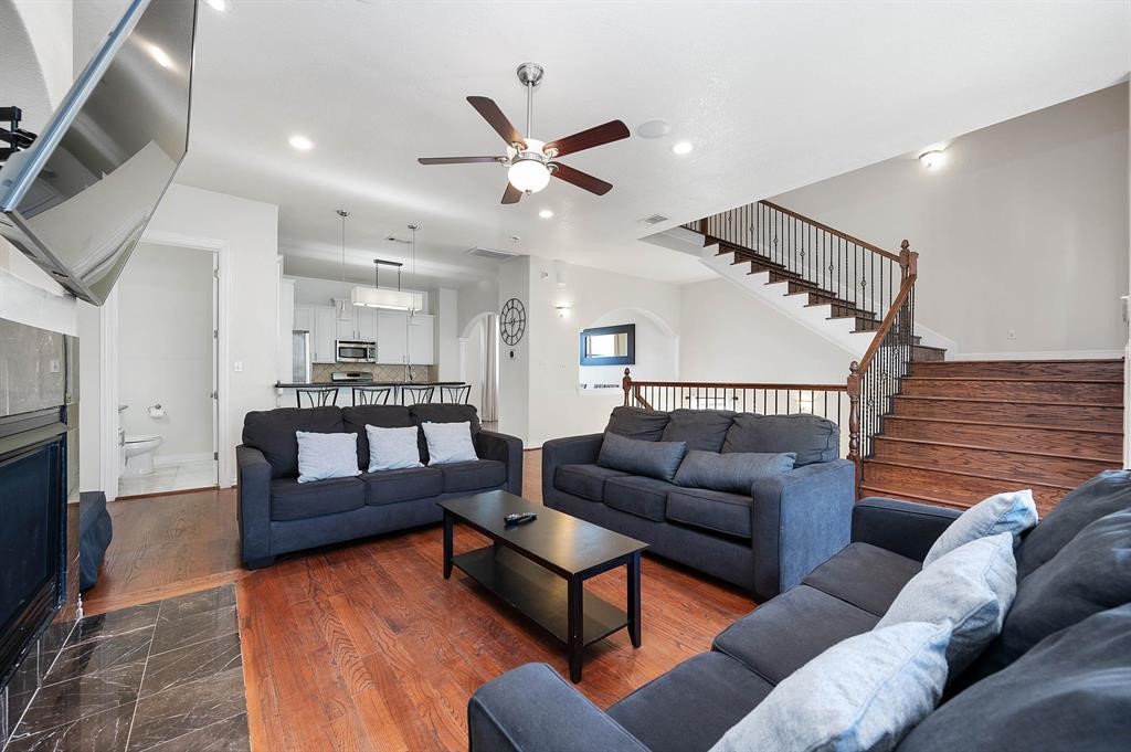 3507 Jackson Street Houston, TX 77004 - Photo 5 of 20 Open-concept living area where hardwood floors and a fireplace create a warm gathering space, with easy connection to the kitchen for effortless daily living and entertaining.