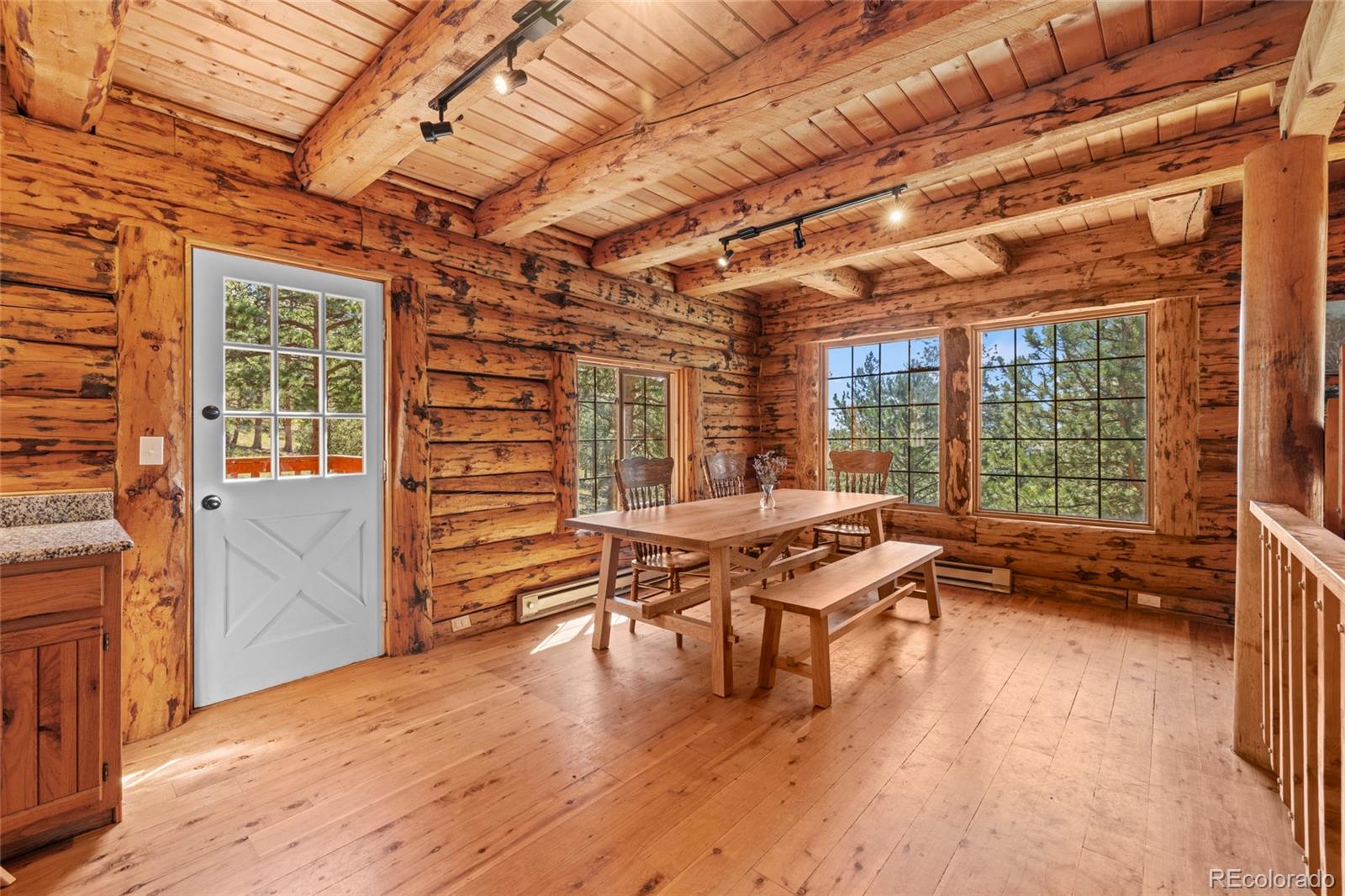 310 Holmes Gulch Road Bailey, CO 80421 - Photo 11 of 48 a dining room with furniture and wooden floor