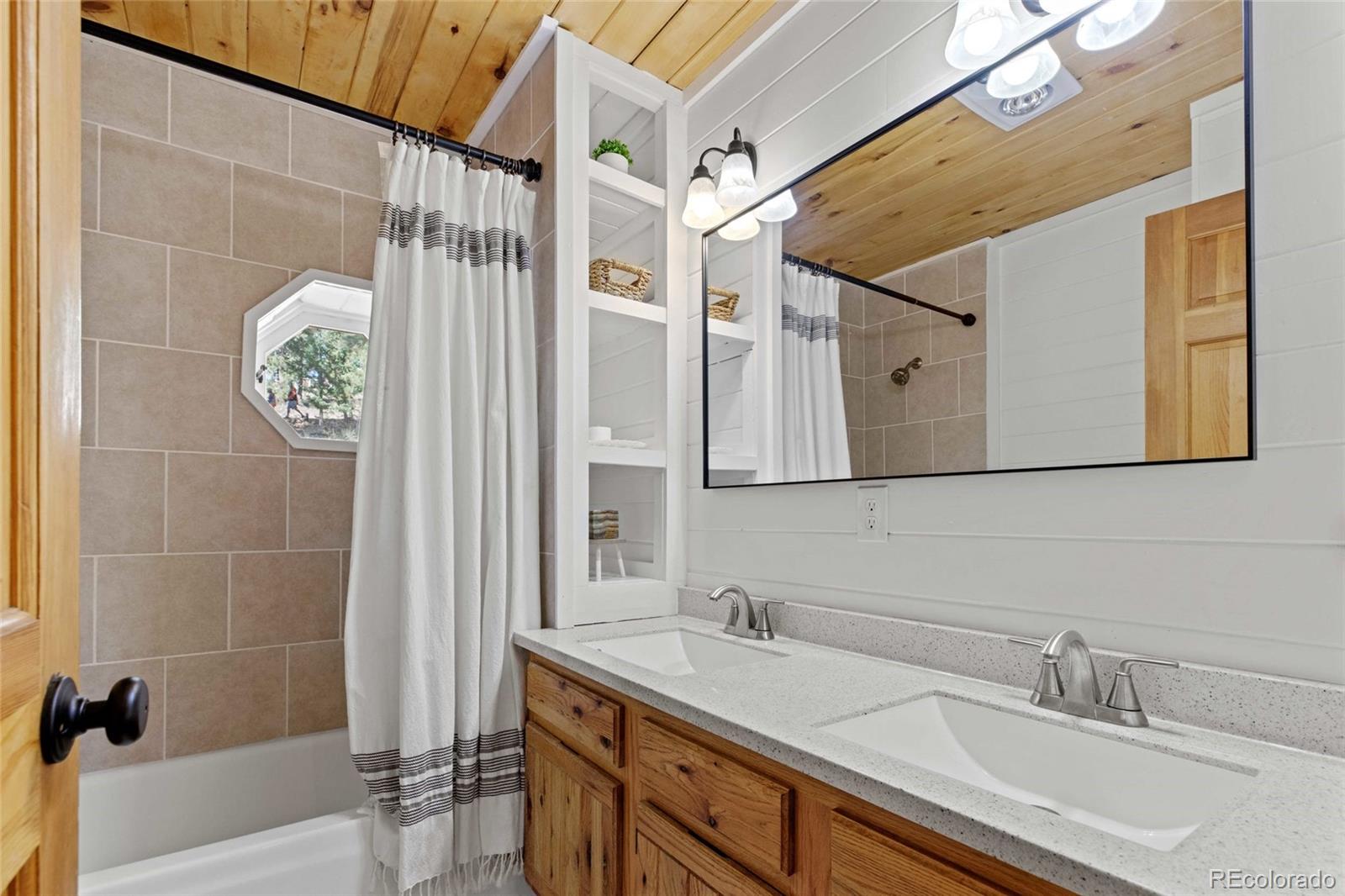 310 Holmes Gulch Road Bailey, CO 80421 - Photo 12 of 48 a bathroom with a sink and a mirror