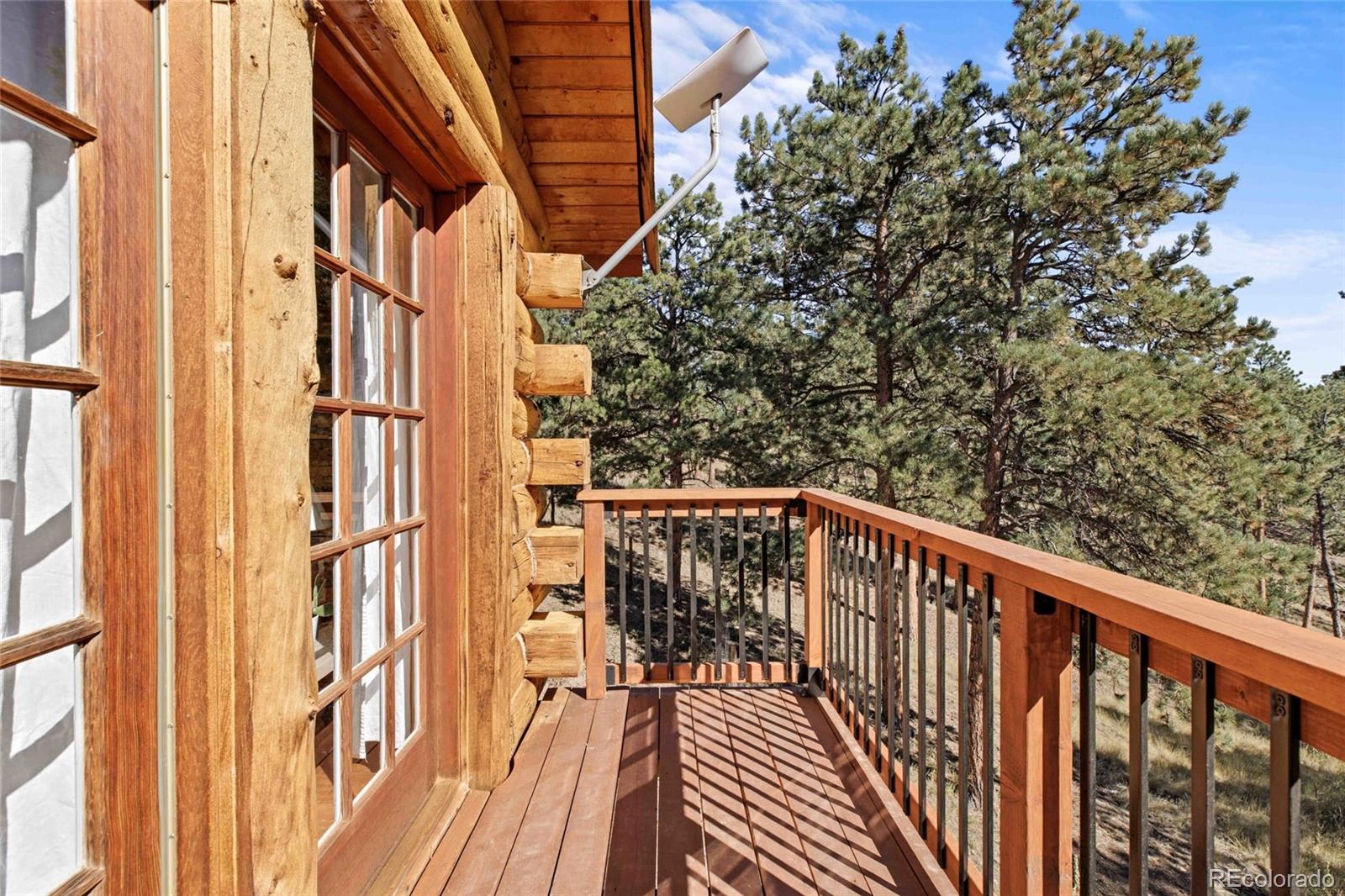310 Holmes Gulch Road Bailey, CO 80421 - Photo 15 of 48 a view of balcony with wooden floor and fence