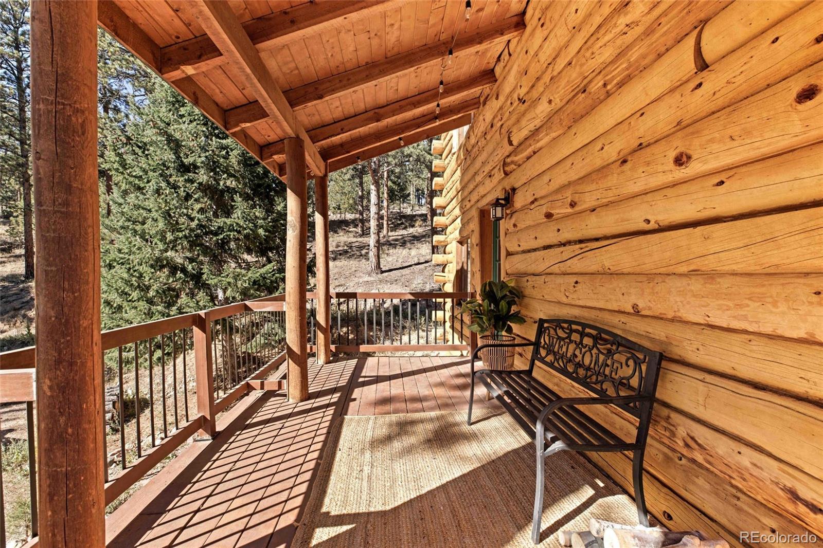 310 Holmes Gulch Road Bailey, CO 80421 - Photo 20 of 48 a view of balcony with wooden floor and fence