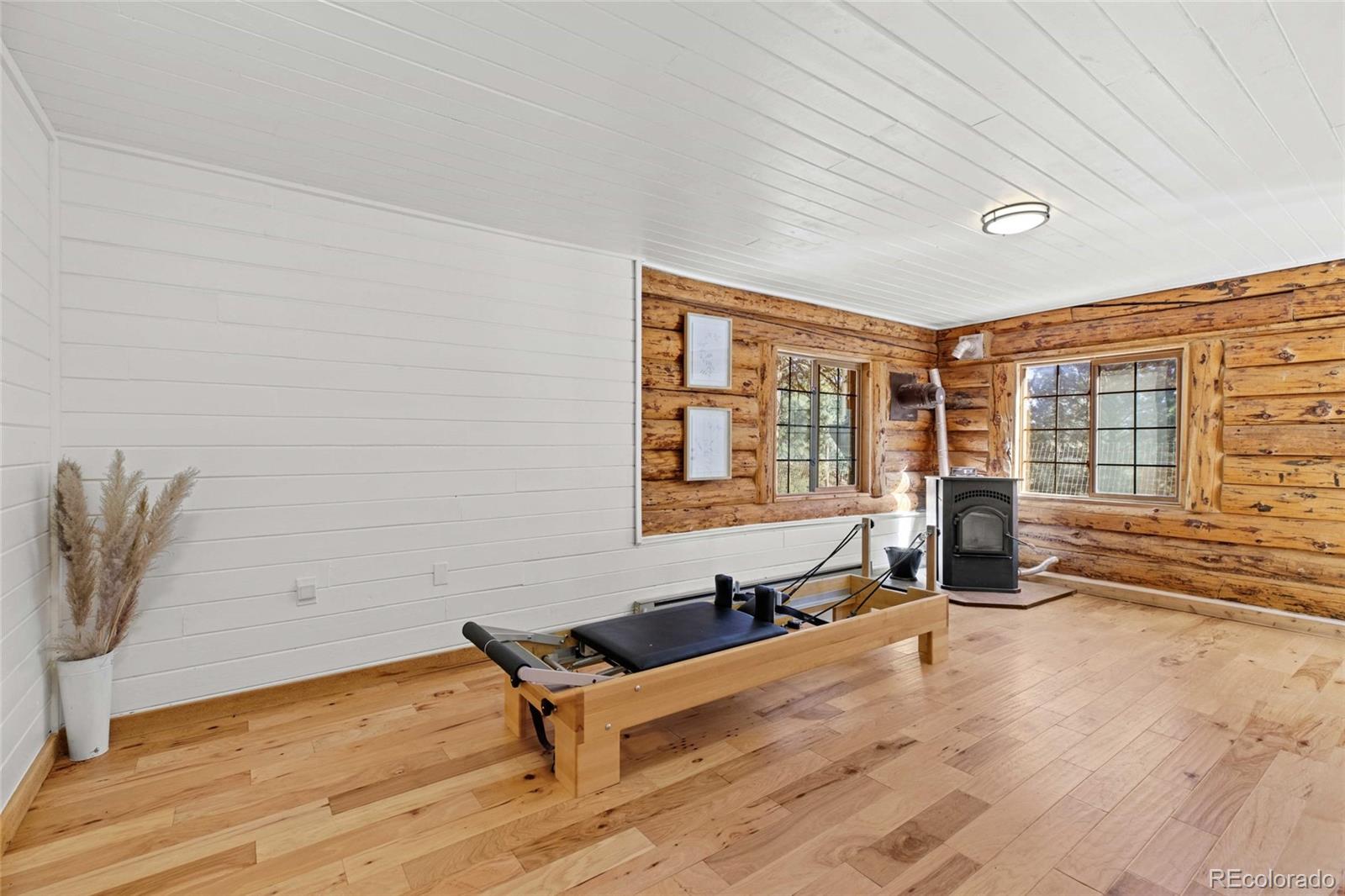 310 Holmes Gulch Road Bailey, CO 80421 - Photo 25 of 48 a view of a room with gym equipment and large window