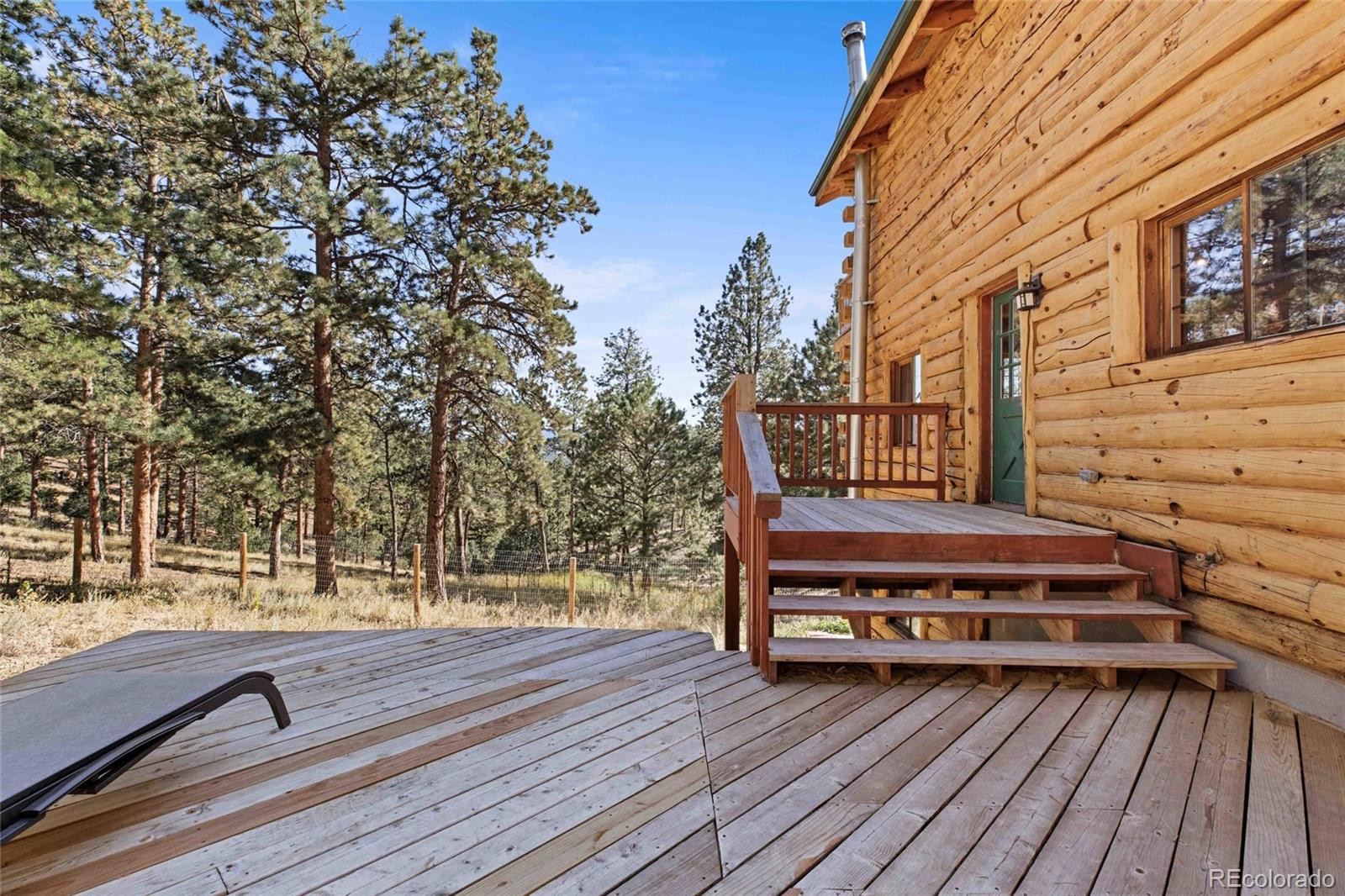 310 Holmes Gulch Road Bailey, CO 80421 - Photo 28 of 48 a view of backyard with wooden deck and trees