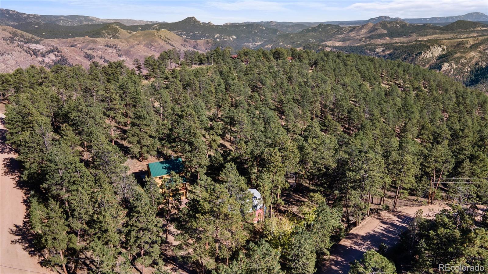 310 Holmes Gulch Road Bailey, CO 80421 - Photo 37 of 48 an aerial view of mountain with residential houses and mountain view
