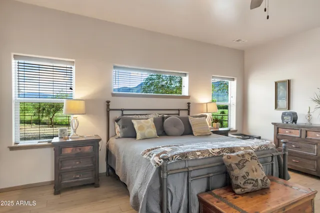 a living room with a bed furniture and next to a window