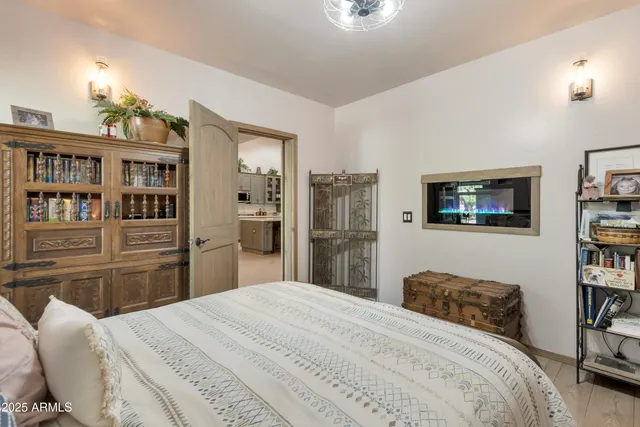 a bedroom with a bed and a book shelf