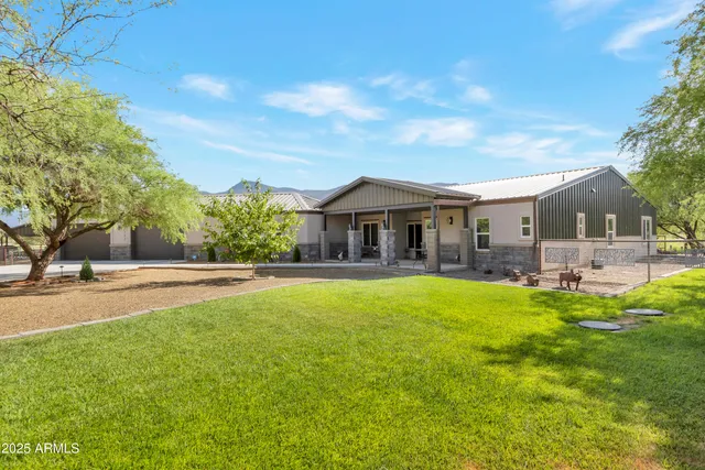 a front view of house with yard and outdoor seating