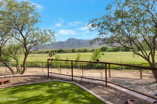 a view of a backyard with wooden fence