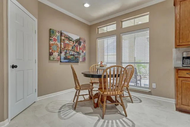 a view of a dining room with furniture and window