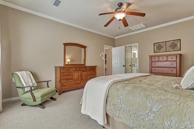 a spacious bedroom with a bed and a chair