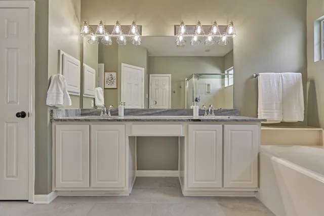 a bathroom with a double vanity sink and a mirror