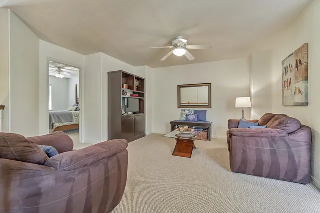 a living room with furniture and a lamp